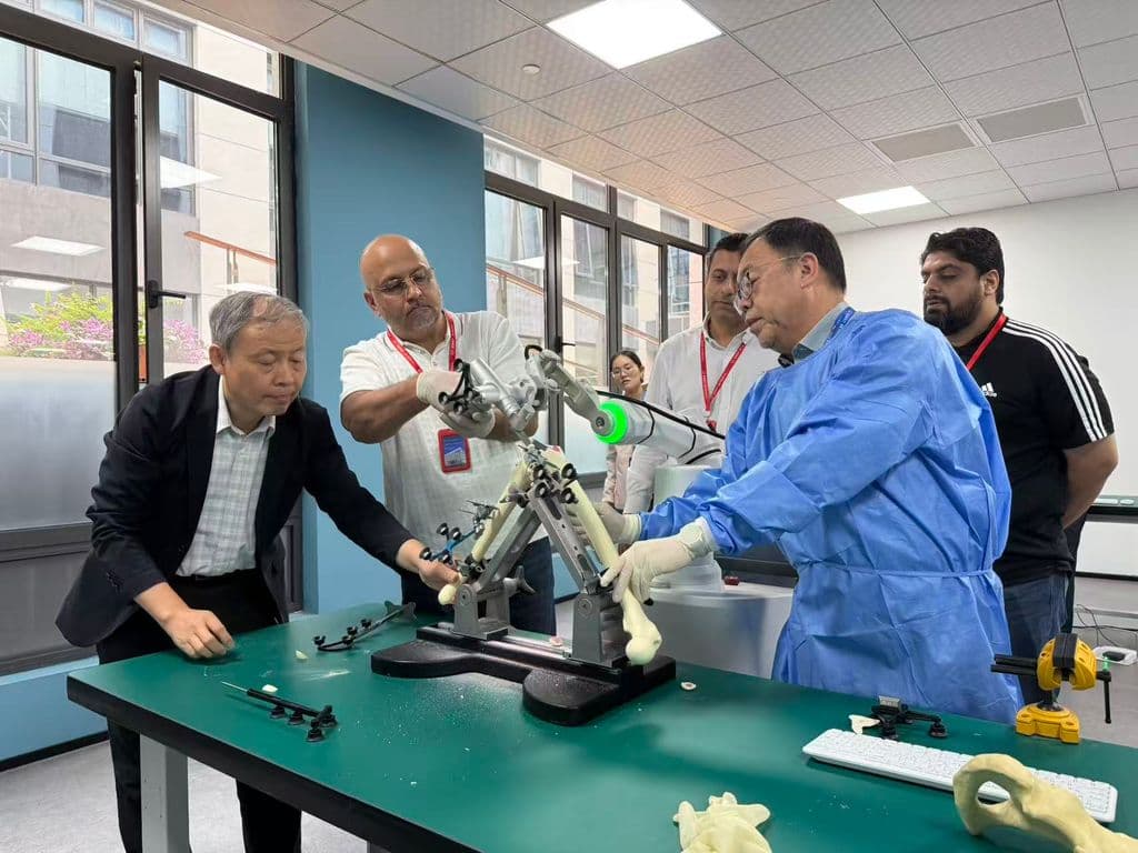 Dr Mujahid Jamil Khattak performing a hands-on robotic-assisted knee replacement demonstration on a bone model during the faculty seminar in China