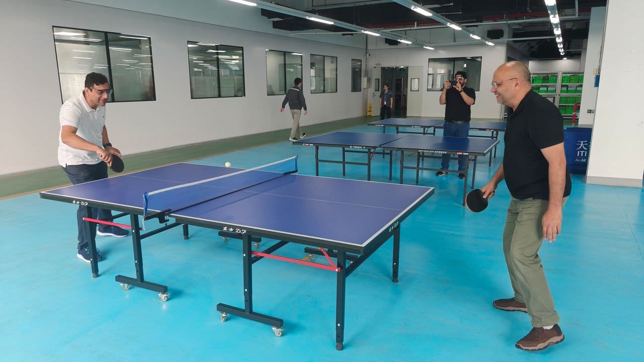 Dr Mujahid Jamil Khattak enjoying a friendly game of table tennis with colleagues during the faculty visit to China
